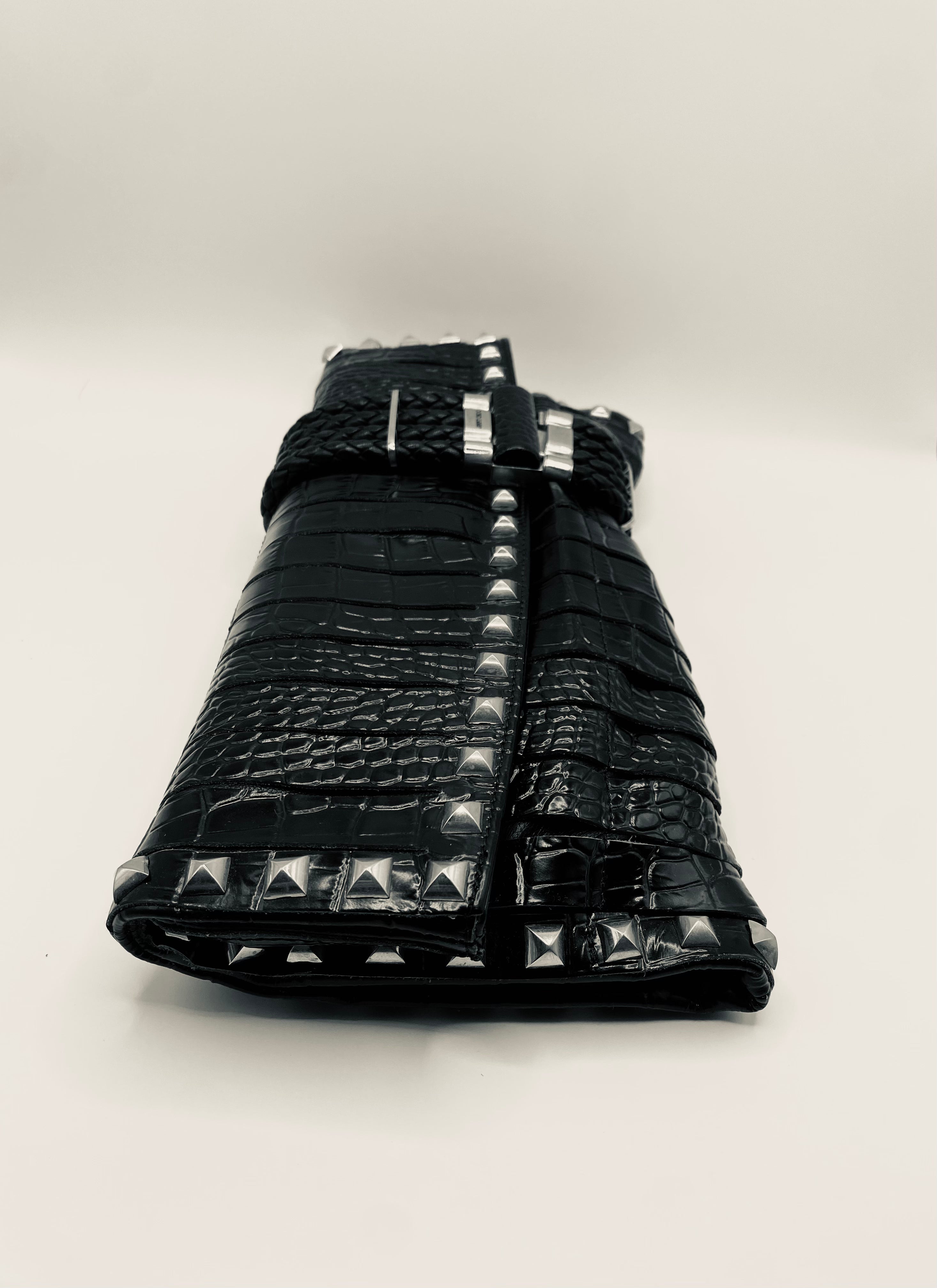 Black leather studded bag on a white background