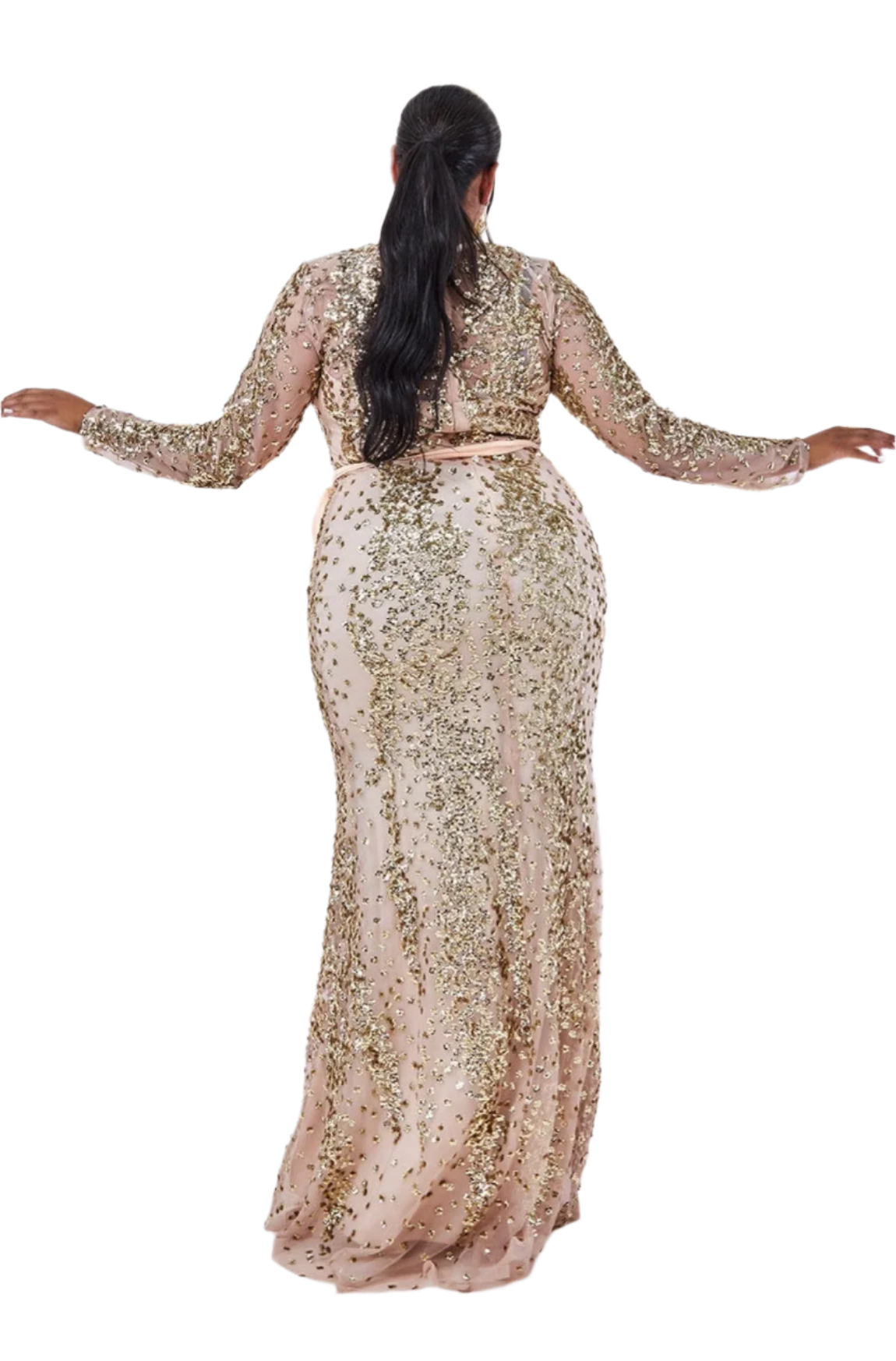 Person wearing a sparkling gold evening gown against a white wall with gold trim.